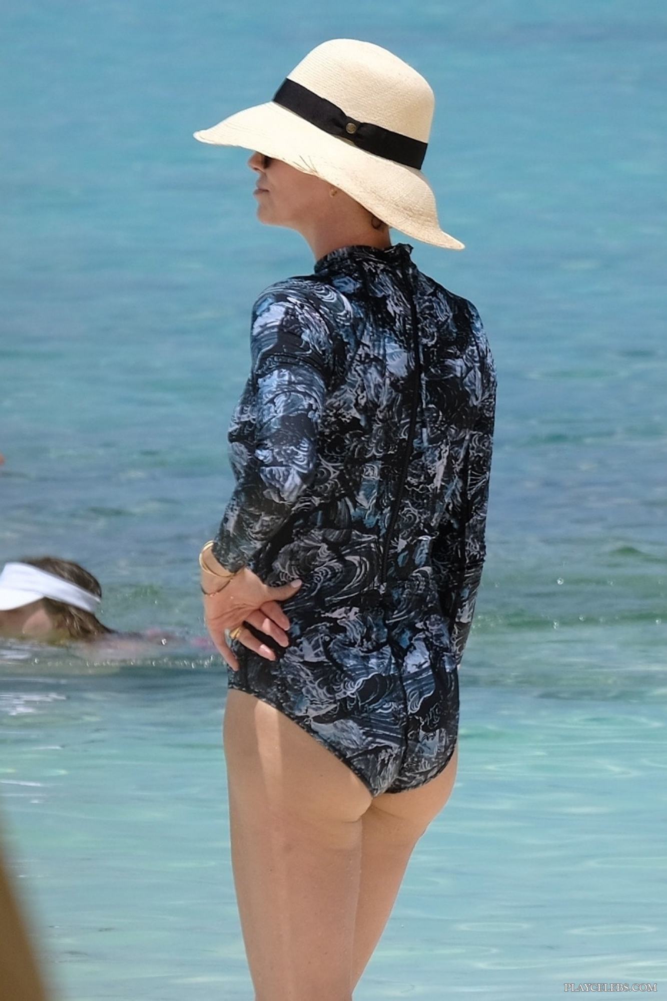 Charlize Theron Caught By Paparazzi In Swimsuit On A Beach